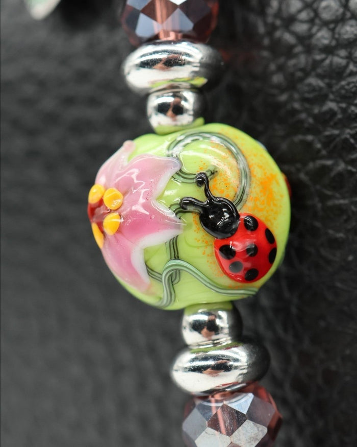 LD Keyfinder Petite Ladybug Love featuring a handcrafted artisan glass bead with a ladybug and flower garden design.