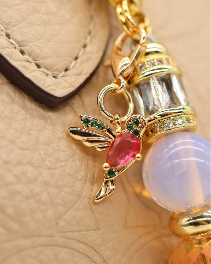 LD Keyfinder Petite Opalite Bloom keychain with a ruby glass hummingbird charm, pink opalite beads, and gold accents.