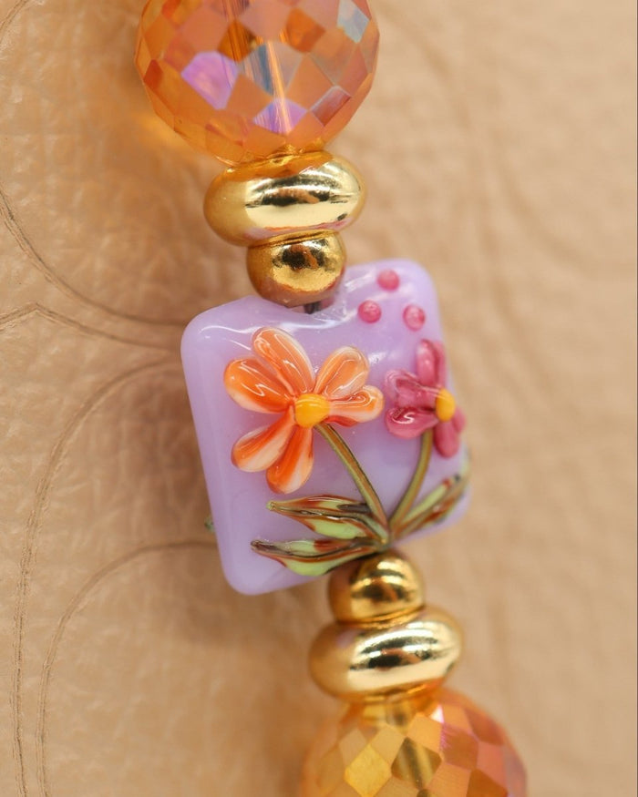 LD Keyfinder Petite Opalite Bloom bracelet with pink and orange flowers, pink opalite, orange glass beads, and gold accents.
