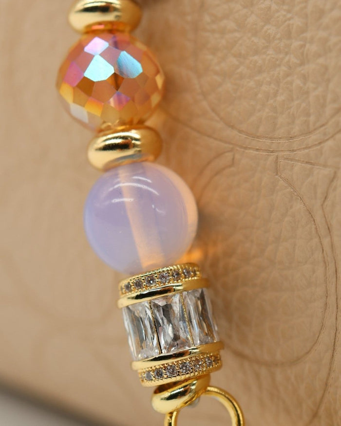 LD Keyfinder Petite Opalite Bloom keychain with pink opalite, orange faceted glass, and crystal baguette beads, gold accents, and hummingbird charm.