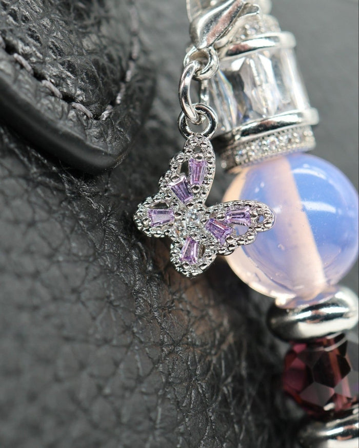 LD Keyfinder Petite Orchid Flutter featuring a purple rhinestone butterfly charm, pink opalite, and dark orchid glass beads.
