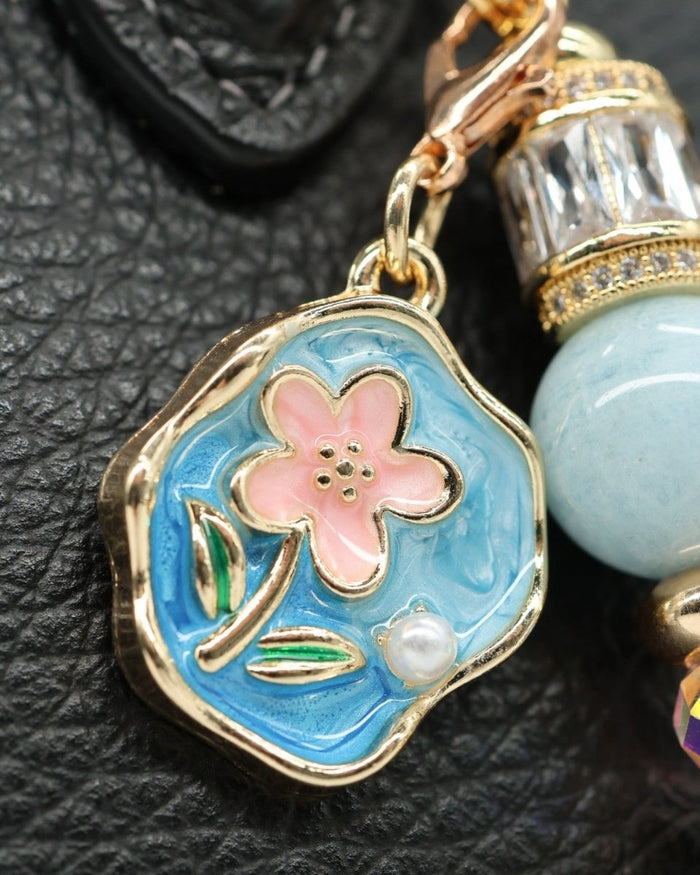 LD Keyfinder Petite Pastel Garden charm: gold-plated enamel flower, aquamarine, pink glass beads, rhinestones, pearl accent.