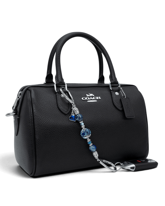 LD Keyfinder Petite Sapphire Allure featuring blue artisan glass, jasper, and jade beads attached to a black handbag.