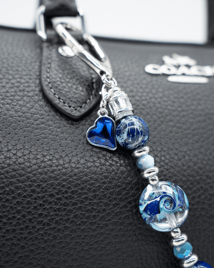 LD Keyfinder Petite Sapphire Allure featuring blue artisan glass, jasper beads, and a sapphire heart charm on a bag.