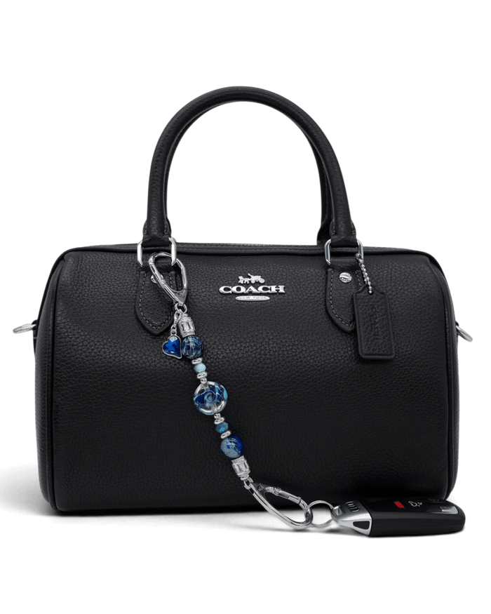 LD Keyfinder Petite Sapphire Allure featuring blue artisan glass, jasper, and jade beads attached to a black handbag.