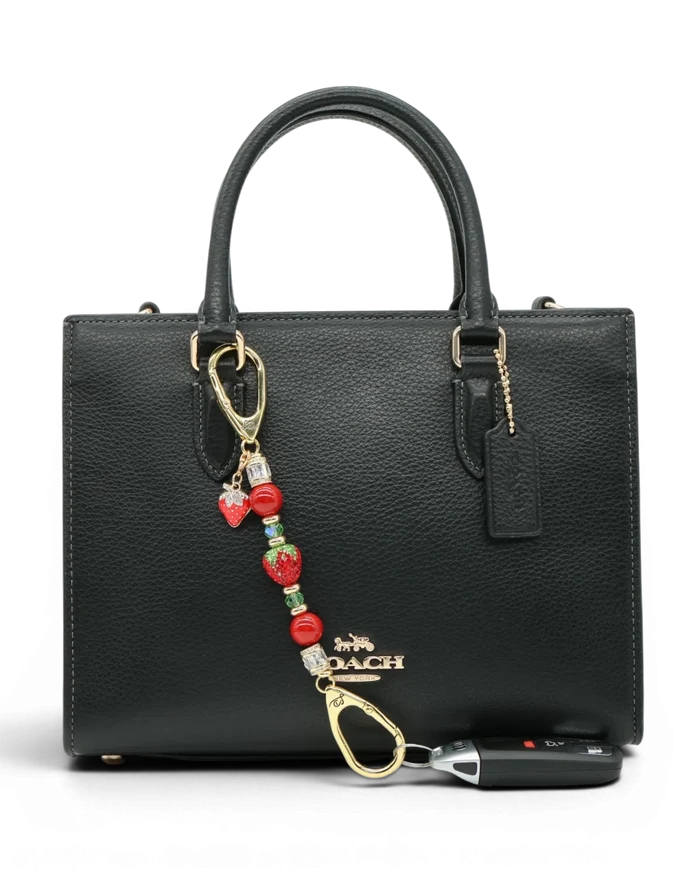 LD Keyfinder Petite Strawberry Fields accessory with red shell pearls, crystal strawberry, and gold-plated charm.