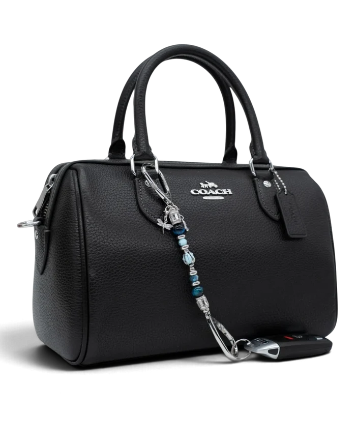 LD Keyfinder Petite Whispering Garden accessory featuring a blue glass tulip, tiger eye beads, and charms on a handbag