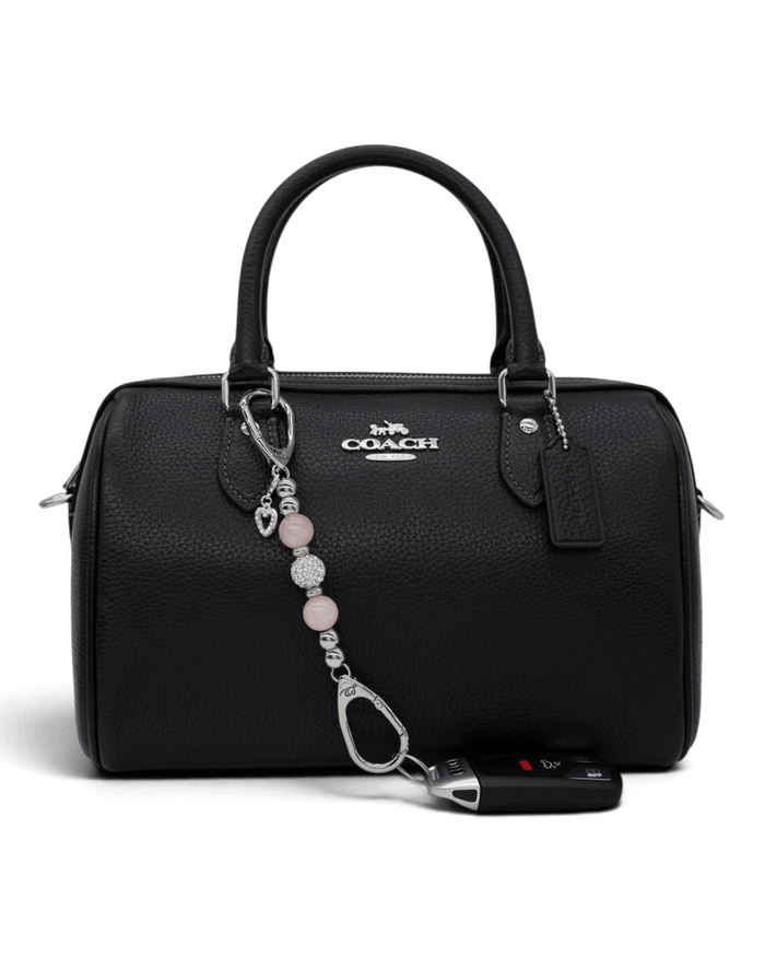 LD Keyfinder Princess Pink-Mini rose quartz beaded keychain with heart charm attached to a black leather handbag.