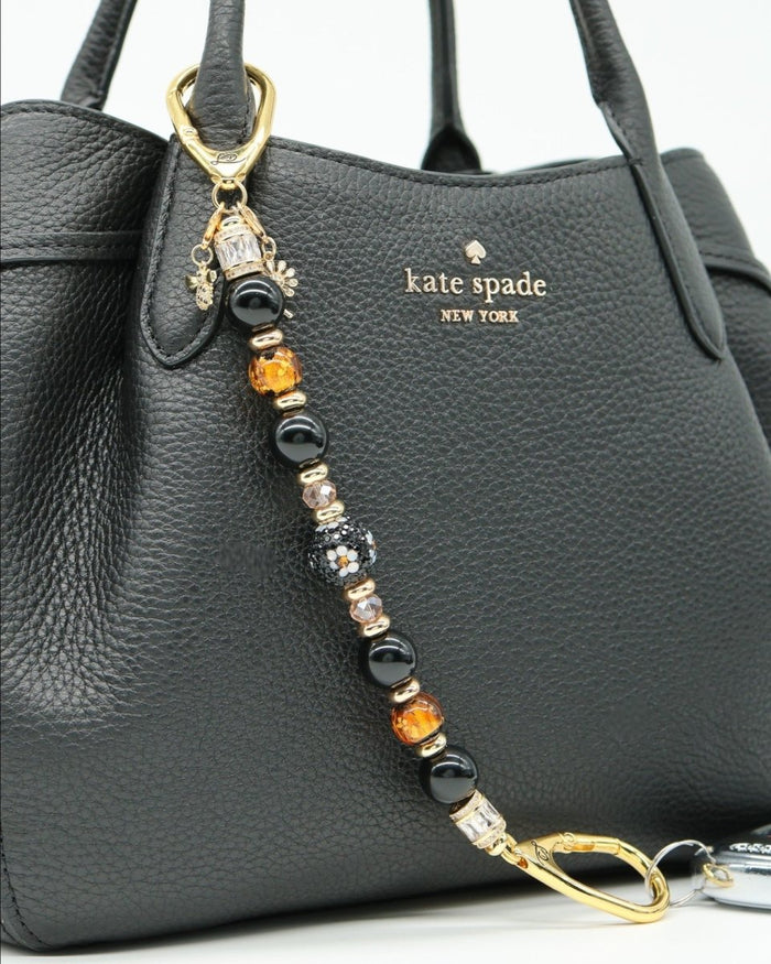 LD Keyfinder Queen Bee II keychain with black obsidian, amber, and gold beads, featuring a daisy charm and bumblebee charm.