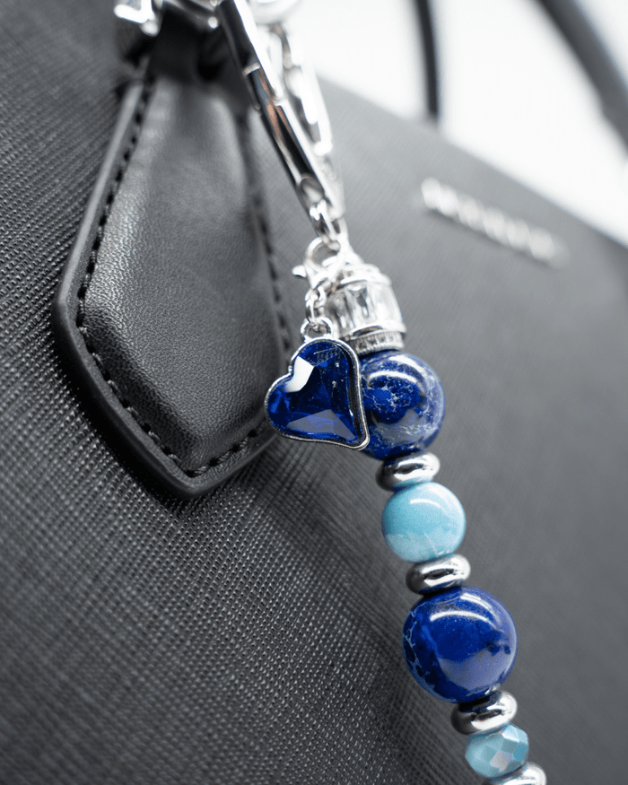 LD Keyfinder Sapphire Allure featuring blue jasper, larimar, and glass beads with a sapphire heart charm on a bag.