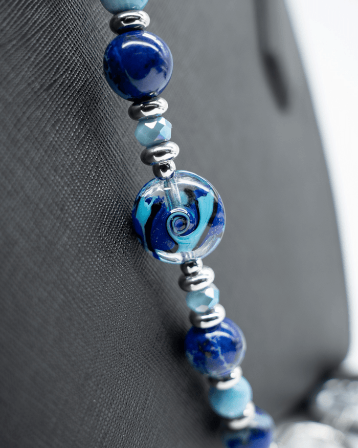 LD Keyfinder Sapphire Allure beaded accessory featuring a handcrafted blue swirling glass bead, Blue Jasper, and Larimar.