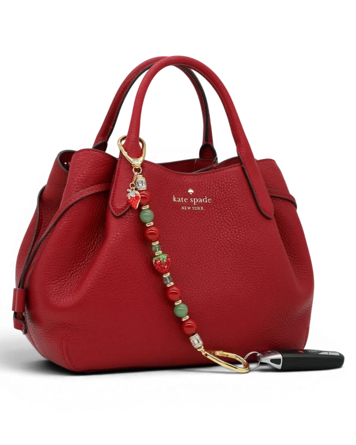 LD Keyfinder Strawberry Fields beaded accessory with red shell pearls, green aventurine, and crystal strawberry charm.