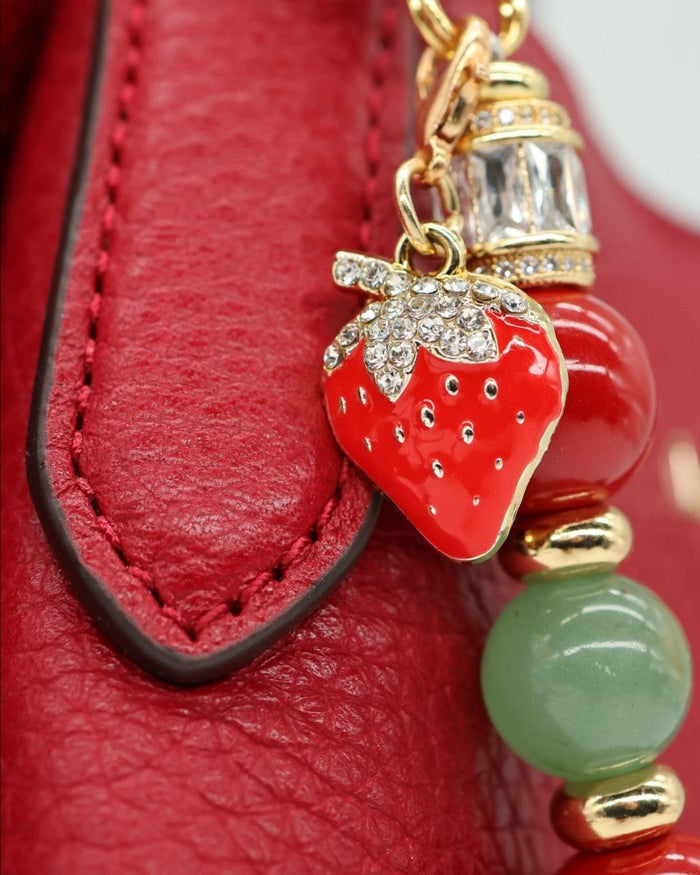LD Keyfinder Strawberry Fields charm with red shell pearls, green aventurine, and gold-plated strawberry detail.