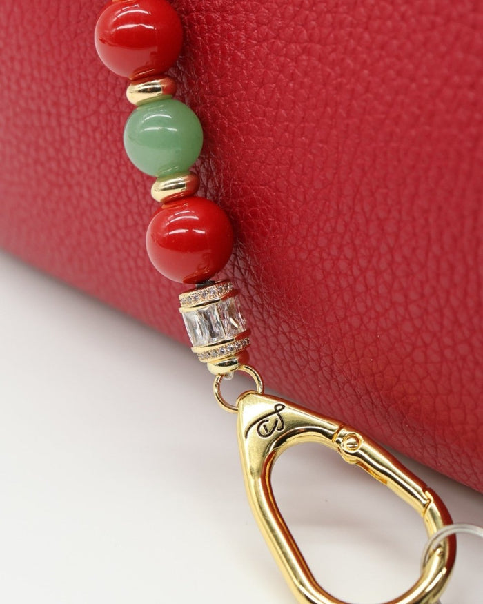 LD Keyfinder Strawberry Fields beaded accessory with red shell pearls, green aventurine, and gold-plated hardware.