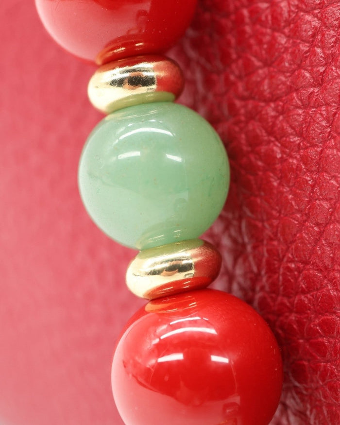 LD Keyfinder Strawberry Fields beaded accessory with red shell pearls, green aventurine, and 18KT gold-plated spacers.