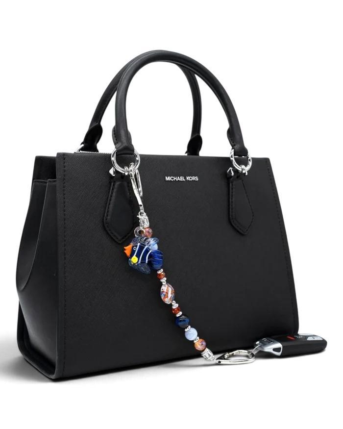 LD Keyfinder Tropical Tango beaded keychain with artisan glass fish charm attached to a black leather handbag