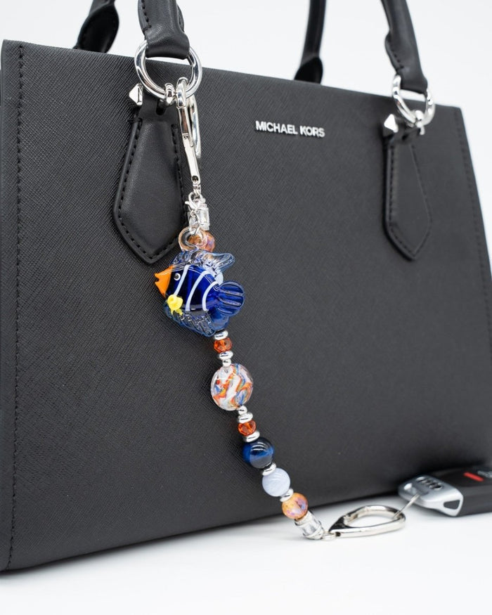 LD Keyfinder Tropical Tango key chain with a lampwork glass fish charm, gemstone beads, and orange glass accents on a bag.