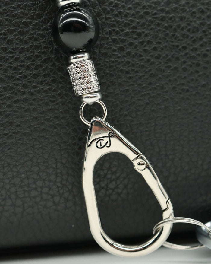 LD Keyfinder Whisker Dreams-Mini featuring black obsidian beads, platinum-plated spacers, and a cat-shaped clasp.
