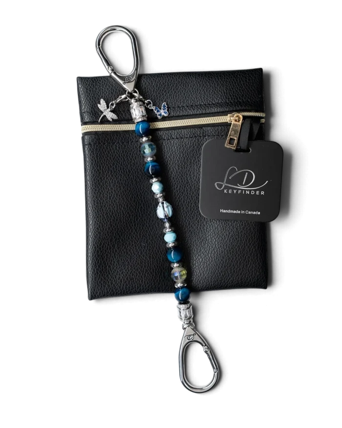 LD Keyfinder Whispering Garden beaded keychain with blue tiger eye, glass tulip, and dragonfly charm on a leather pouch.