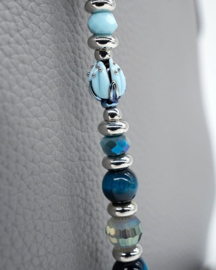 LD Keyfinder Whispering Garden beaded accessory featuring a handcrafted blue glass tulip and blue tiger eye beads.